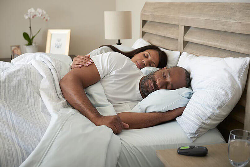 Woman and Man Sleeping in a Bed
