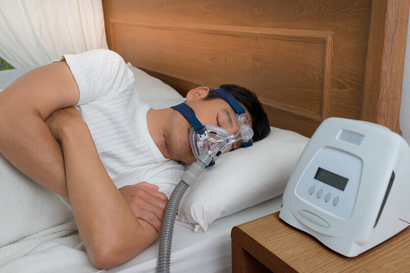 Man Sleeping With a CPAP Machine